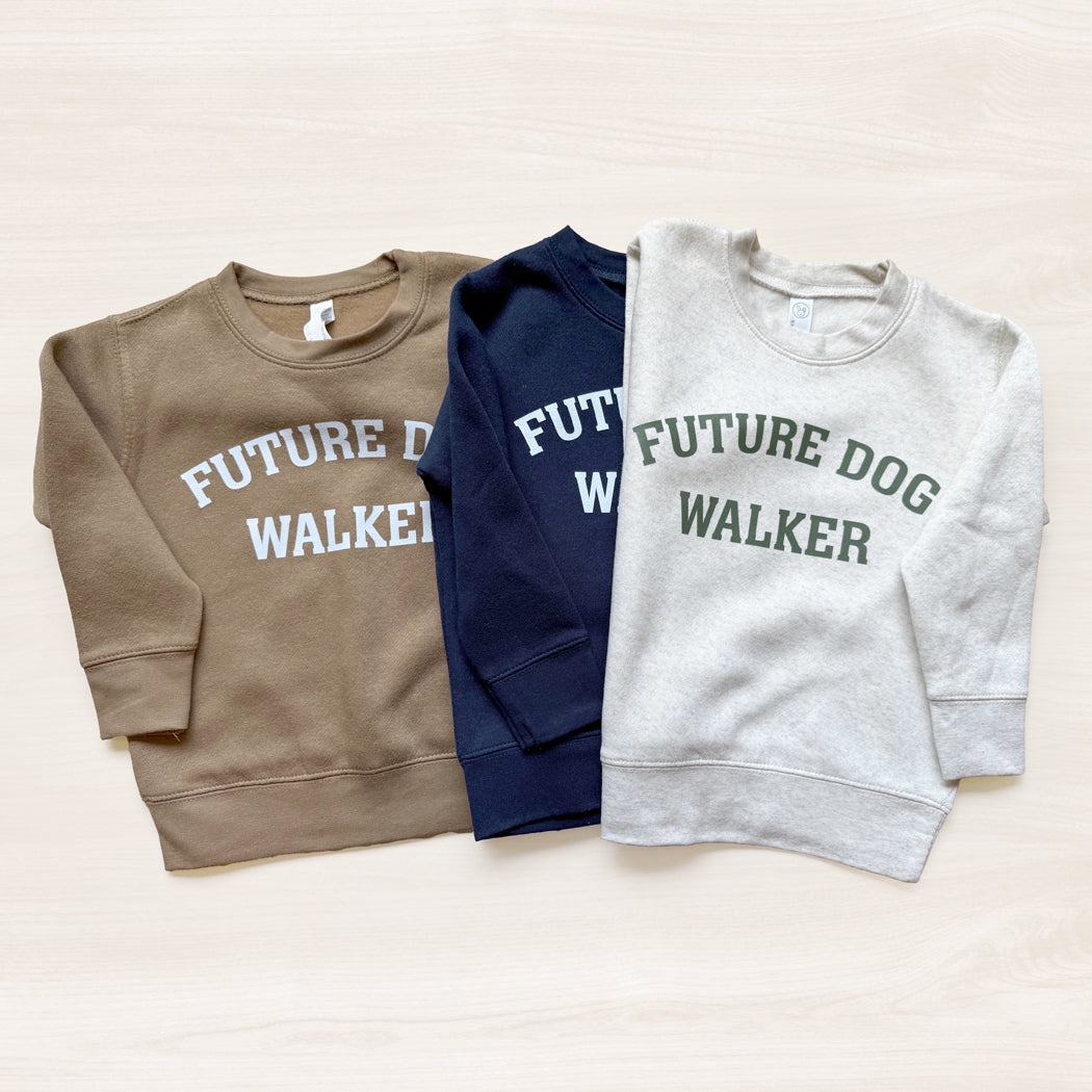 Three sweatshirts with 'Future Dog Walker' text in different colors on a light background