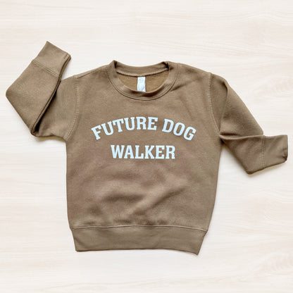 Brown sweatshirt with 'Future Dog Walker' text on a light beige background
