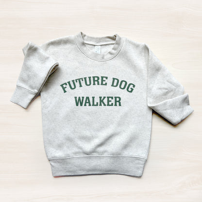Gray sweatshirt with 'Future Dog Walker' text on a light beige background