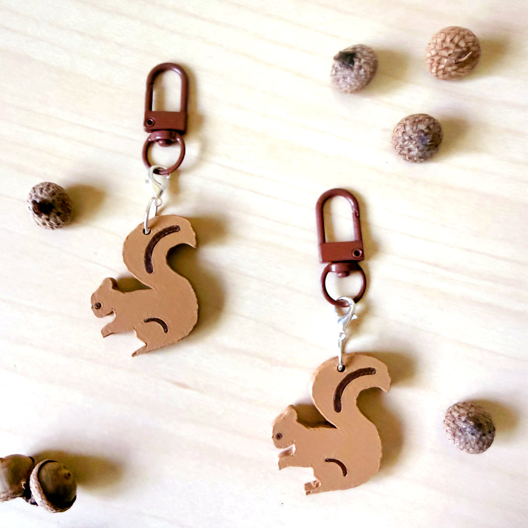 Collectible squirrel dog collar charm clipped to a leather dog collar, designed for dog lovers by Poppy & Lou.
