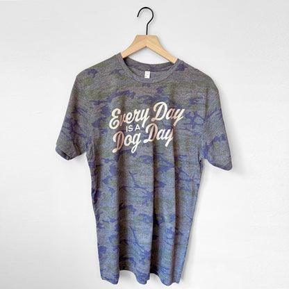Camouflage t-shirt with 'Every Day is Dog Day' text on a hanger against a white background