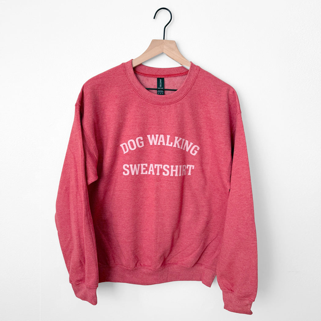 Red sweatshirt with 'Dog Walking Sweatshirt' text on a white background