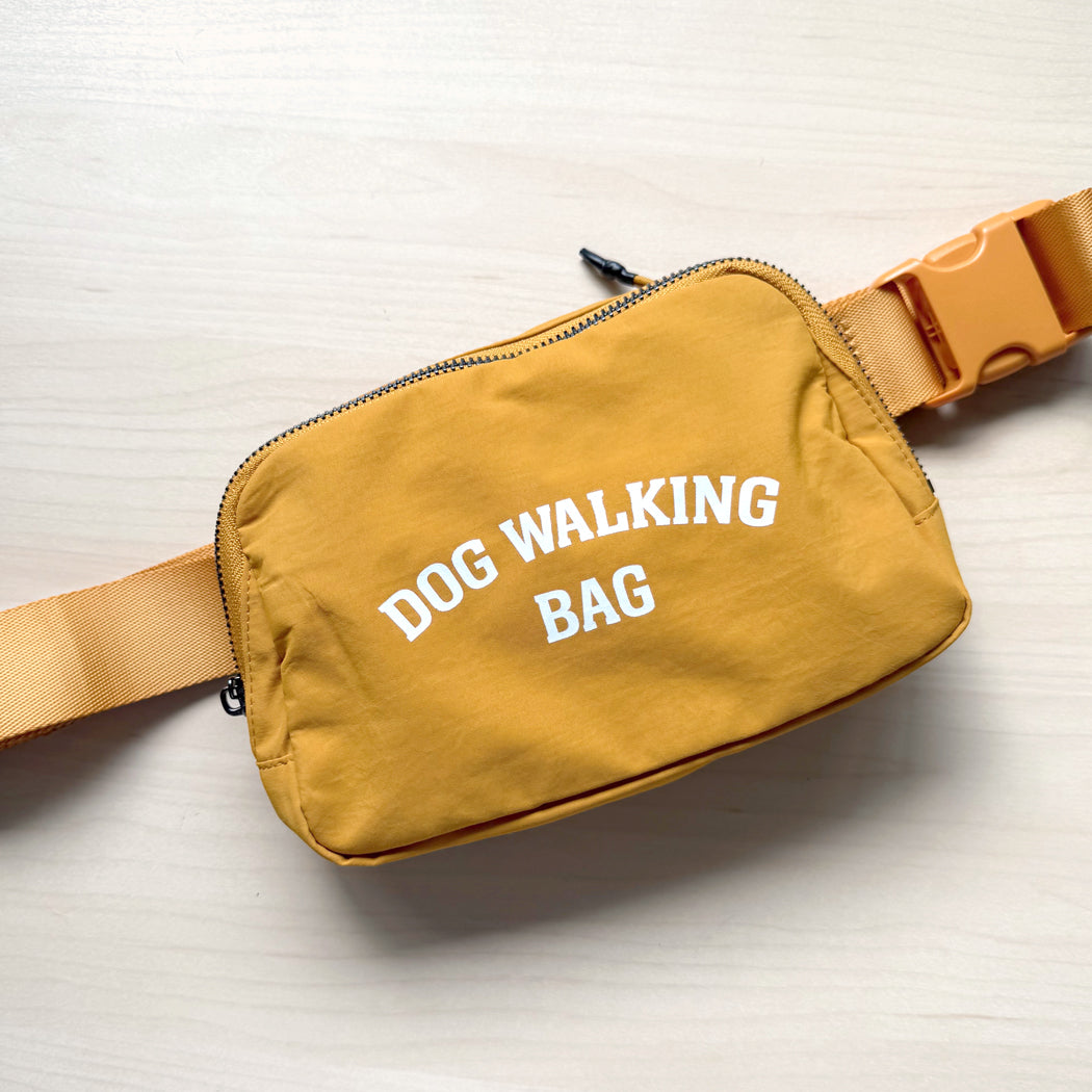 Dog Walking Bag shown in yellow with adjustable strap and front zipper pocket