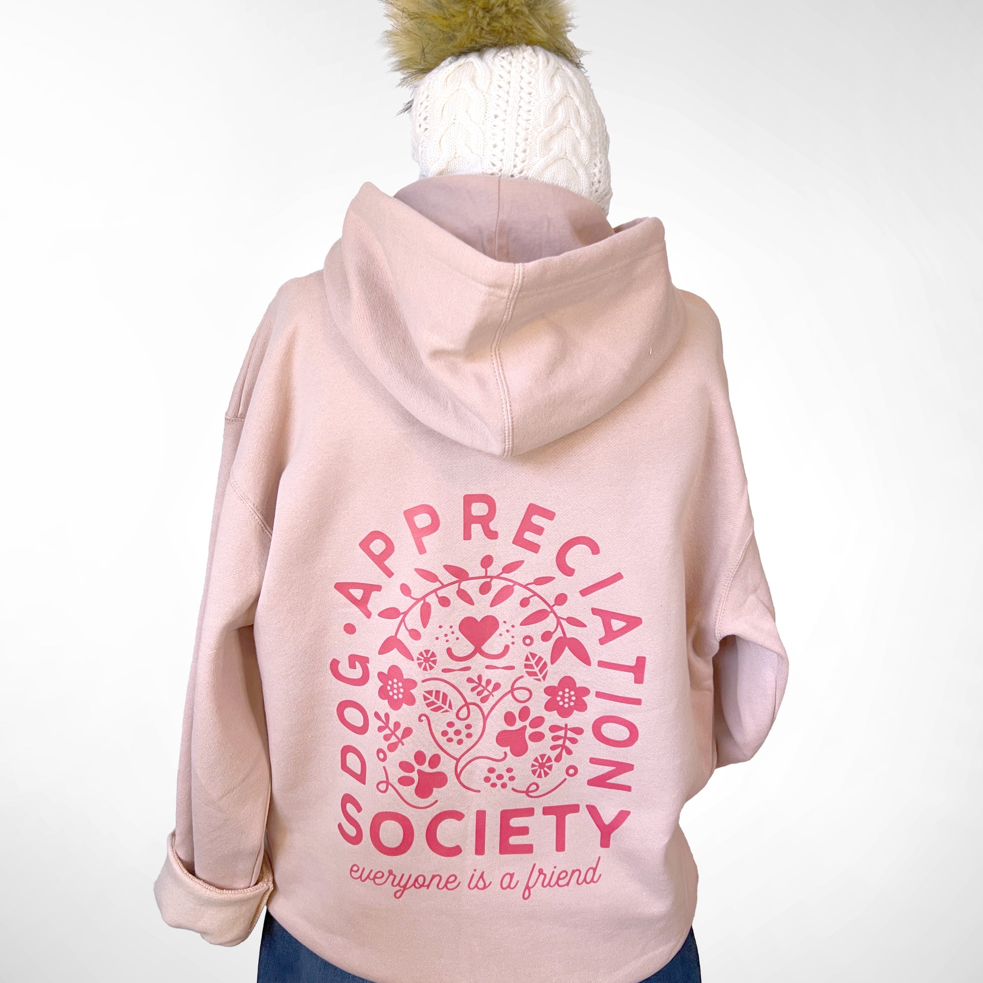 Back view of dusty pink Dog Appreciation Society Hoodie with hand-illustrated design.