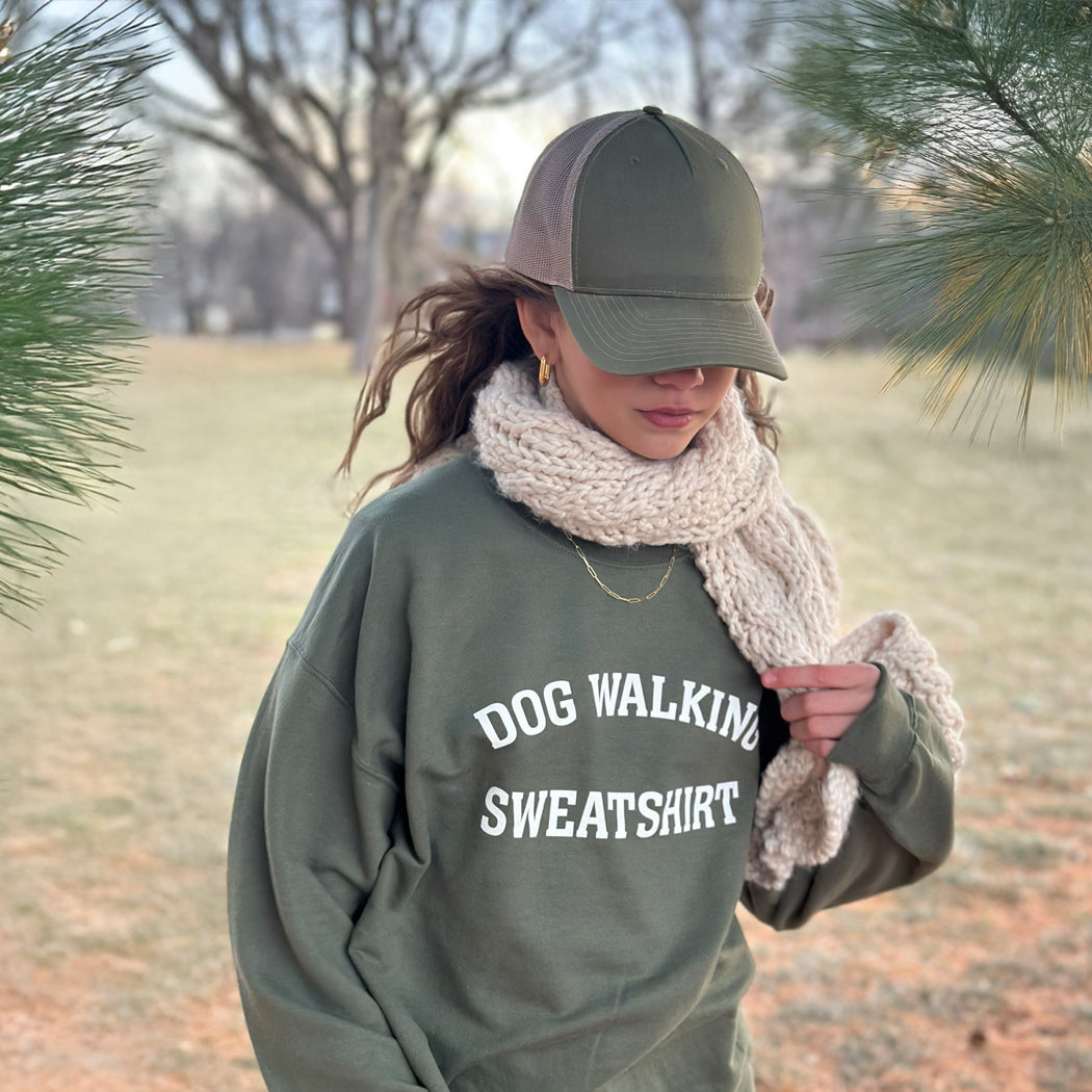 Front view of unisex army green Dog Walking Sweatshirt with white text.