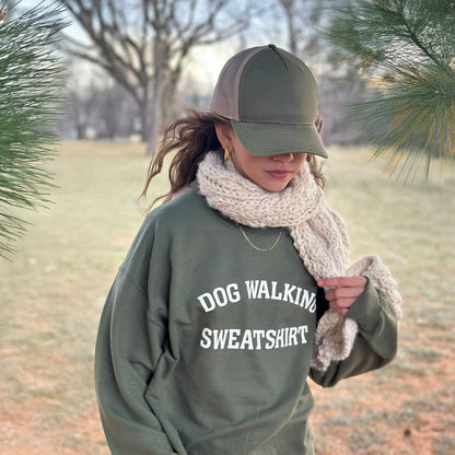 Front view of unisex army green Dog Walking Sweatshirt with white text.