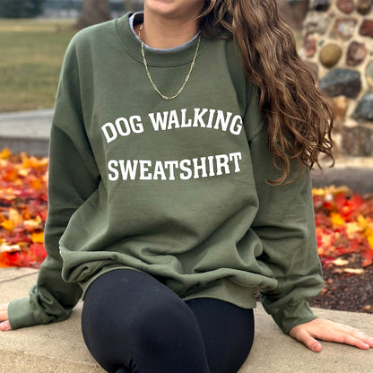 Front view of unisex army green Dog Walking Sweatshirt with white text.
