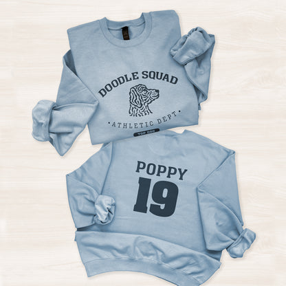 Two light blue sweatshirts with text and graphics on a white background