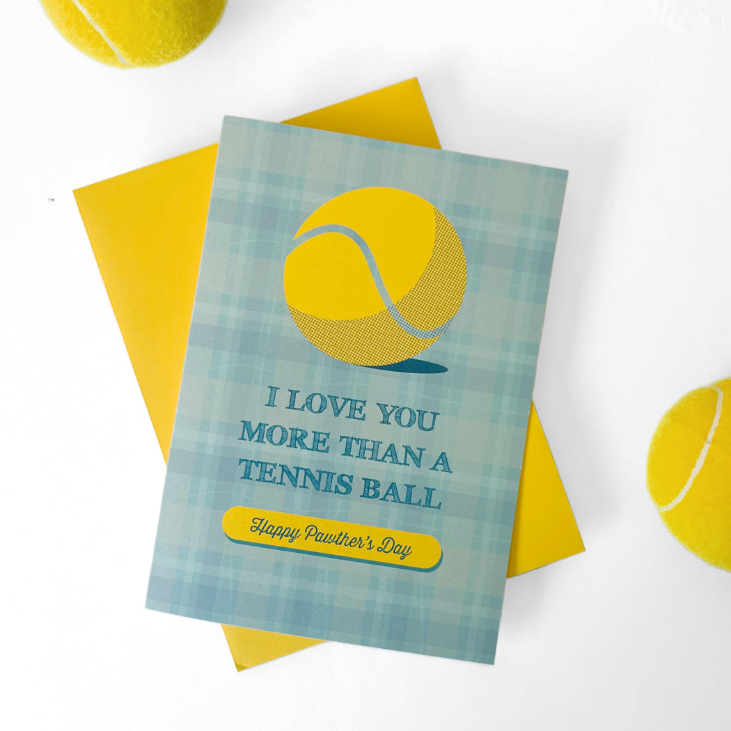 Front view of Dog Dad Father's Day Card featuring blue plaid design with yellow tennis ball graphic and 'I Love You More Than A Tennis Ball. Happy Pawther's Day'