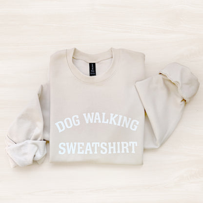 Beige sweatshirt with 'DOG WALKING SWEATSHIRT' text on a light beige background