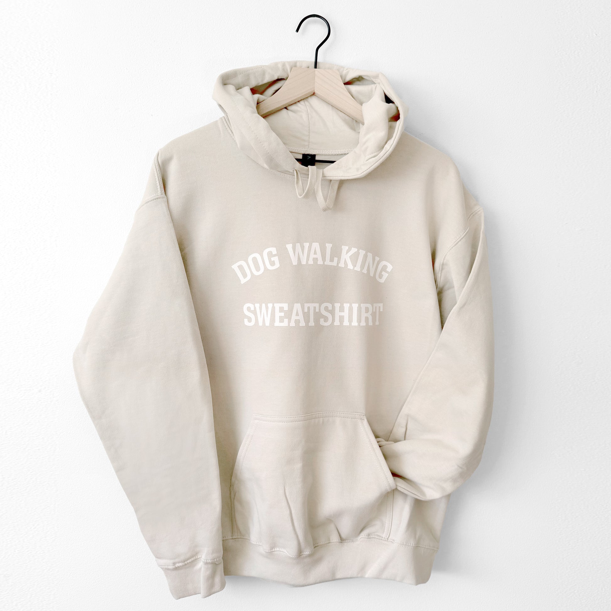 Beige hoodie with 'DOG WALKING SWEATSHIRT' text on a white background