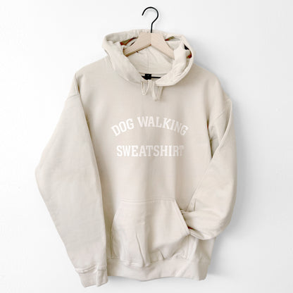Beige hoodie with 'DOG WALKING SWEATSHIRT' text on a white background